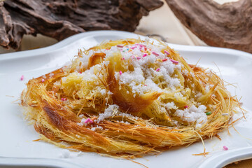 A nest of sesame seed cakes on a white porcelain plate