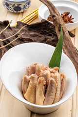 Salted duck wings in a white porcelain bowl
