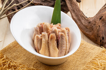 Salted duck wings in a white porcelain bowl