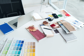 Interior Design Workspace with Color Swatches and Laptop for Creative Projects and Material...