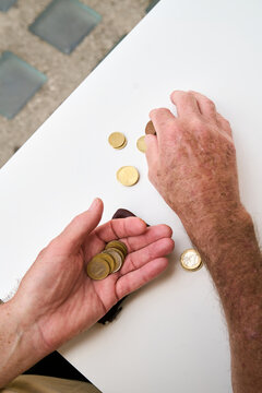 Retired Man Counting Euro Coins