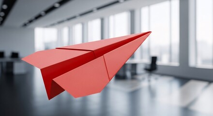 red paper airplane flying in modern office concept

