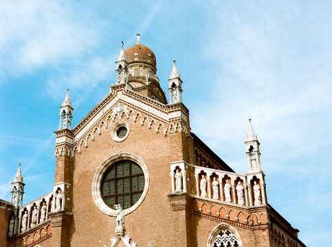 Gothic pink marble and bricks church against blue sky