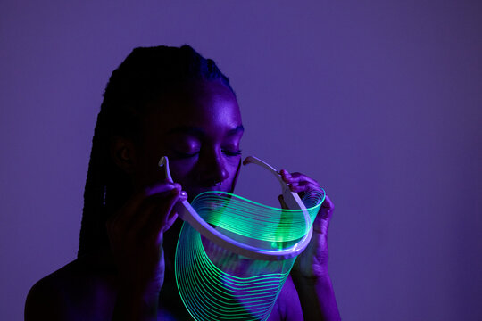 Neon Green Light Visor in Low Key Lighting