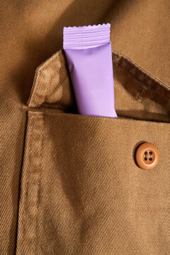 Purple sachet of single-serving collagen powder visible from a pocket.