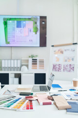 Interior Design Studio Workspace with Color Swatches Fabric Samples and Laptop Computer for Creative Inspiration and Architectural Planning