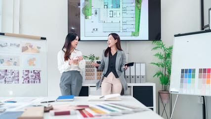 Asian Interior Designers Collaborate on Project Floor Plan Asian Architects Discussing Design Blueprint and Color Palettes for Modern Interior Design Project