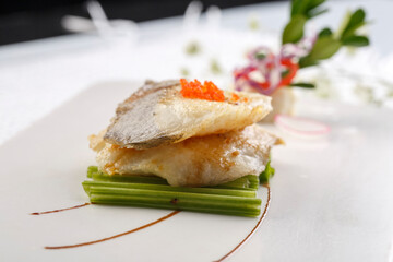 Sizzling Russian cod on a white porcelain plate