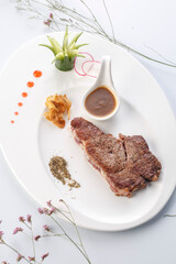 Angus sirloin steak on a white porcelain plate