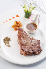 Angus sirloin steak on a white porcelain plate
