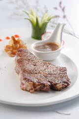 Angus sirloin steak on a white porcelain plate