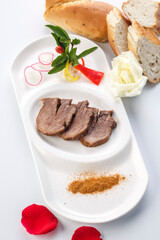 Braised beef tongue in sizzling sauce on a white porcelain plate