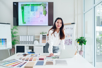 Asian Architect Woman at Office Desk with Laptop Planning Project Interior Design and House...