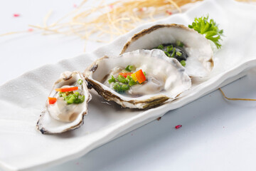 Grilled oysters in shell served on a plate