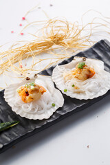 Sizzling scallops with garlic vermicelli served in exquisite tableware