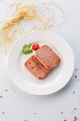 Grilled salt and pepper luncheon meat in exquisite tableware