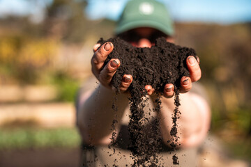 women in agriculture looking at a soil sample. girl on a farm looking at plant roots, female farmer...