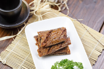 Rounded long porcelain plate with flavored hairtail fish