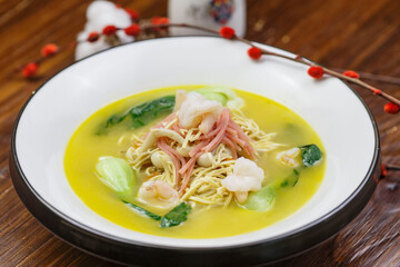 White round porcelain plate with ham, shrimp and dried shredded pork in thick soup