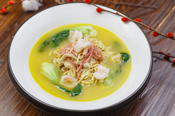 White round porcelain plate with ham, shrimp and dried shredded pork in thick soup