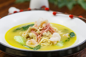 White round porcelain plate with ham, shrimp and dried shredded pork in thick soup