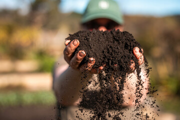 women in agriculture looking at a soil sample. girl on a farm looking at plant roots, female farmer...