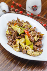Stir-fried pork with spring bamboo shoots in a leaf-shaped porcelain plate