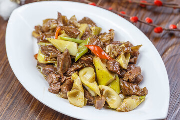 Stir-fried pork with spring bamboo shoots in a leaf-shaped porcelain plate