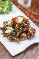 Sweet and sour sea eel on a rectangular white porcelain plate