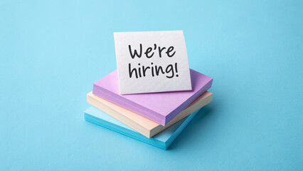 Job labor employment, unemployment. We're hiring message sticky notes, recruitment announcement, blue background, job opportunity . Hiring rate, economic growth, opening workforce market