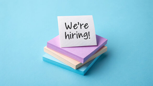 Job labor employment, unemployment. We're hiring message sticky notes, recruitment announcement, blue background, job opportunity . Hiring rate, economic growth, opening workforce market
