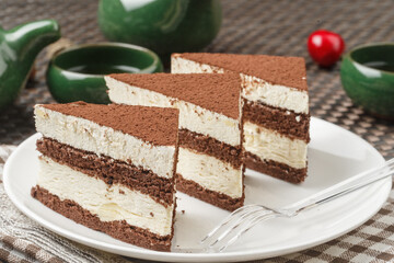 Chocolate dusted cream mousse on tablecloth