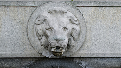 Stone lion head fountain in downtown Vilnius