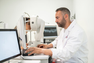Ophthalmologist performing eye exam on patient using medical equipment