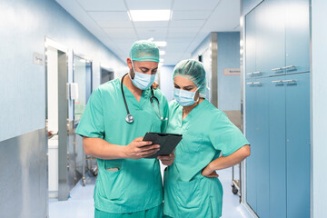 Surgeons using digital tablet are consulting patient data