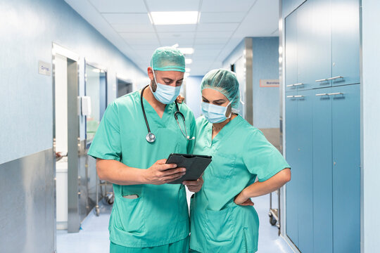 Surgeons using digital tablet are consulting patient data