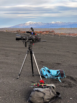 Professional camera setup on volcanic black ground