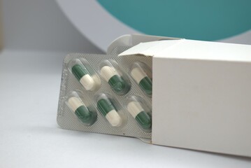 High-quality image of pharmaceutical pills, capsules, and blister packs arranged on clean...