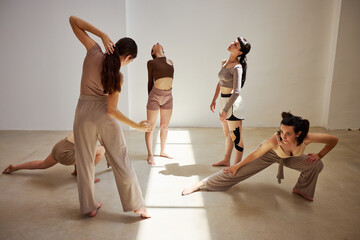 Five dancers express creativity through movement in studio setti