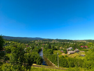 A view of a small town in the middle of a lush green valley
