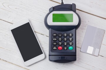 Flat design payment setup is showing smartphone, card terminal and credit card on wooden tabletop