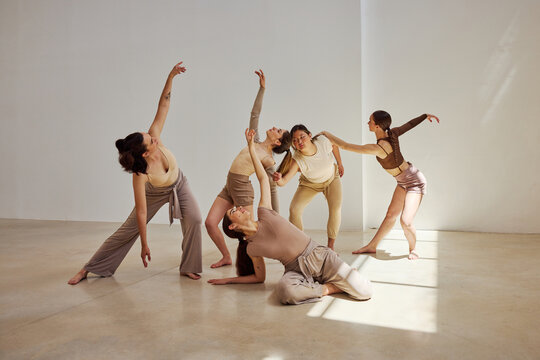 Contemporary dance performance by a group of female dancers in s