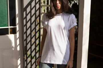 Woman is standing in sunlit home entryway flat design, with wooden trellis vine and colored glass