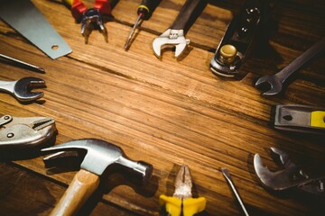 Flat design vector illustration is depicting hand tools arranged on wooden workbench, copy space