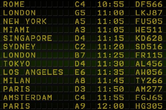 Black airport departures board with yellow text