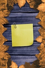 Autumn leaves with yellow note