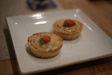 Strawberry-Topped Round Pastries on a Square Plate