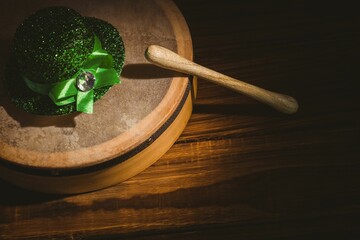 High angle view of badhran with green hat on wooden table