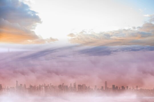 Fototapeta Flat design city skyline silhouette is rising through pink purple fog, with orange pink blue clouds