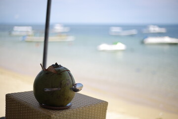 Fresh Young Coconut with Spoon by the Ocean